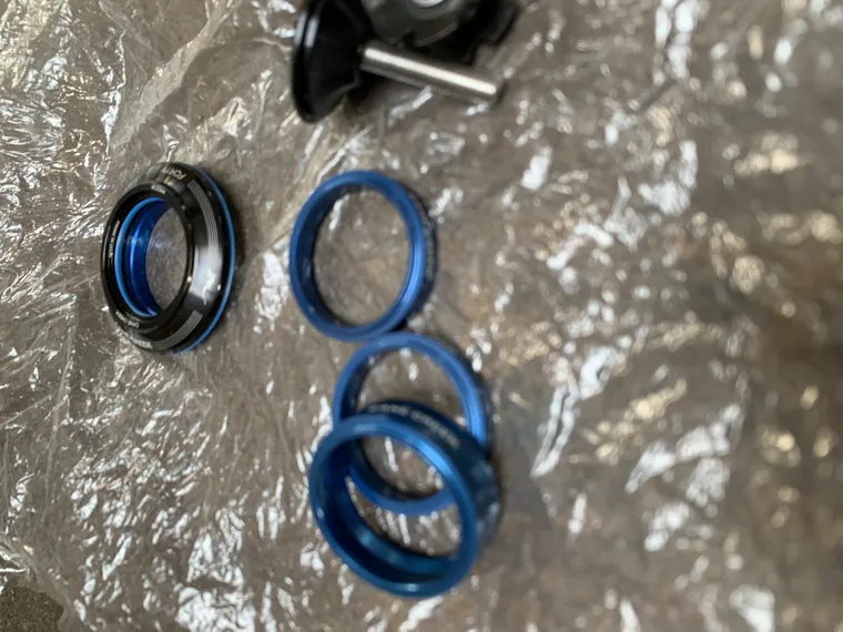 Blue Cane Creek headset bearings and races laid out on foil.