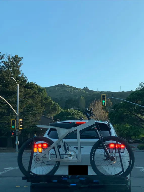 The Nacho loaded on a car rack, stopped at a traffic light.