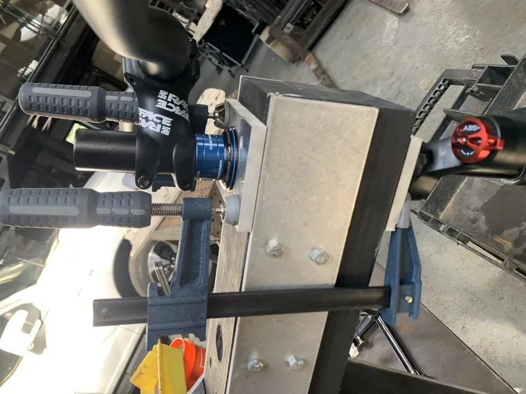 The stem, bars, and controls being assembled on the bench.