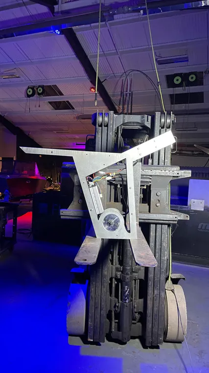 The frame hanging from the forklift, seen from a lower angle.