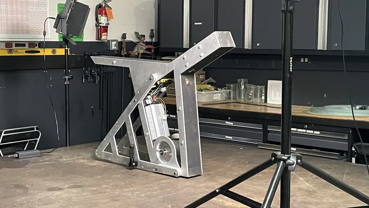 The finished aluminum frame standing on a stand in the workshop.
