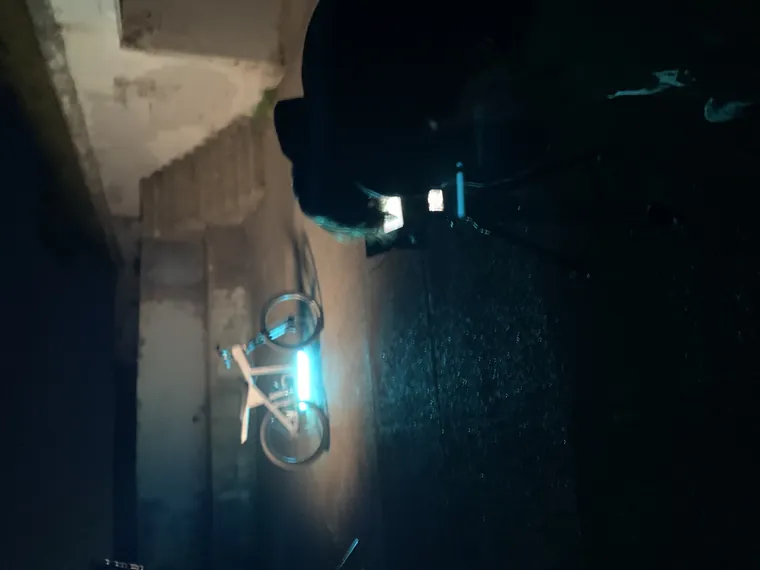 The Nacho suspended in a dark garage, outlined in teal light.