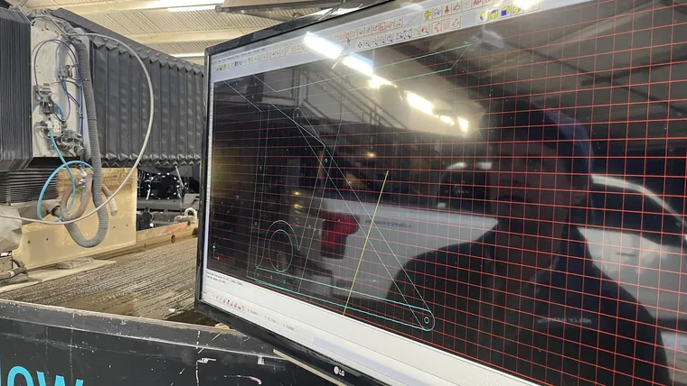Looking through the window of a machine tool at a part being cut.