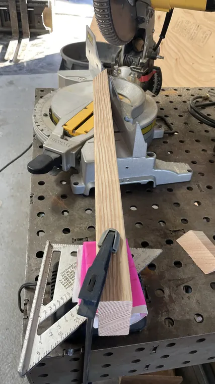 Lengths of Doug fir 2x4 on a miter saw bench, cut to angle.