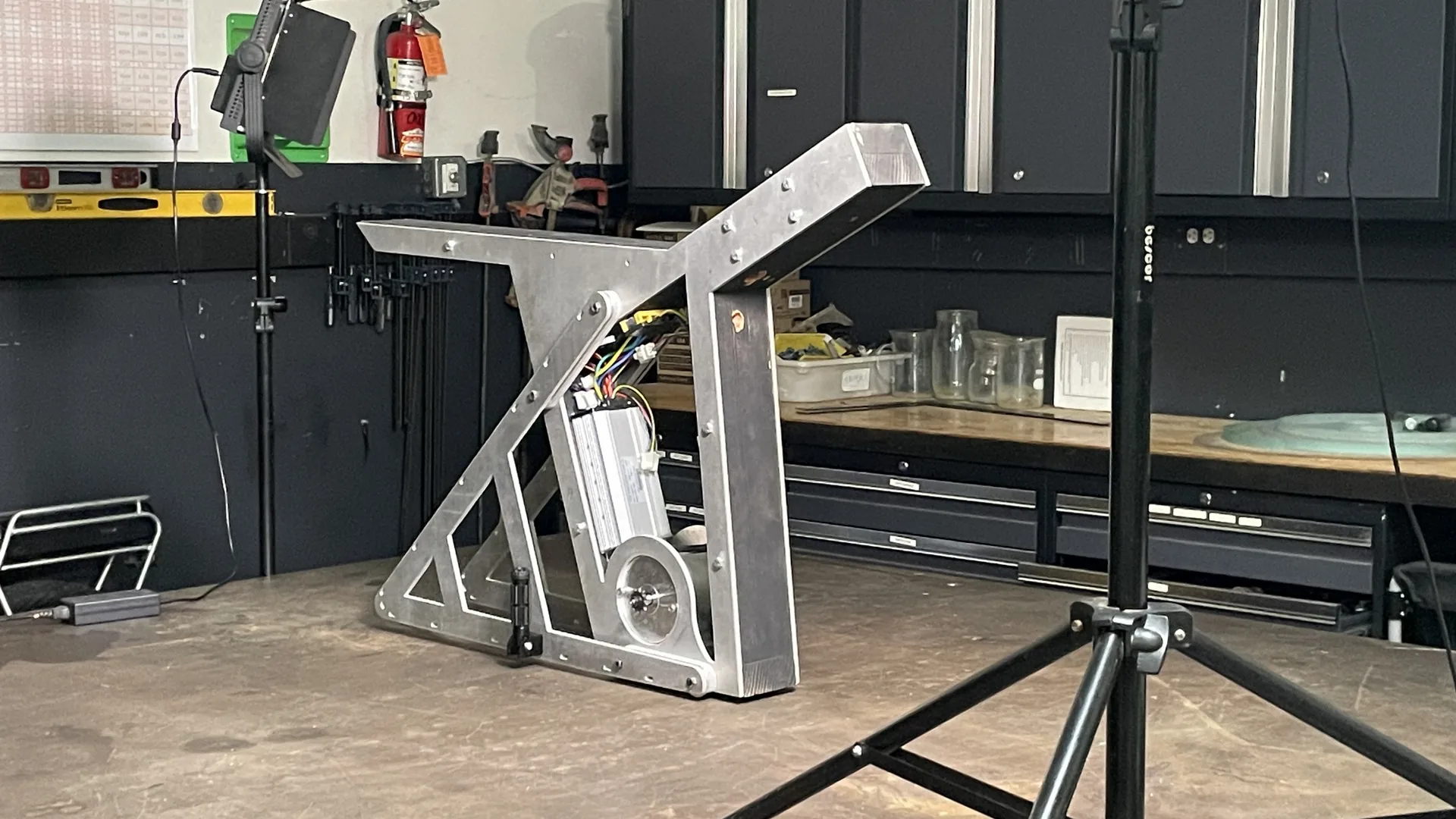 The finished aluminum frame of The Nacho standing on a stand in the workshop.